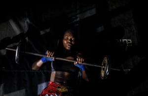 Eniola lifts weights. She has blue handwrap on each hand