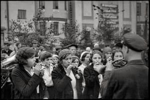 Girls’ Kazoo Band, Moscow, USSR A uniformed brass player leads the band.In the USSR he captured a street parade, a girls’ kazoo band, and theatrical productions, including the Moscow State Yiddish Theater and the Moscow Children’s Theater.