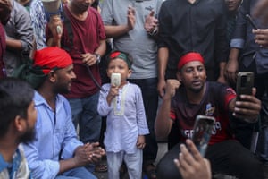 A child holding a microphone at a protest