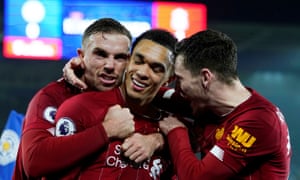 Liverpool’s Trent Alexander-Arnold (centre) celebrates with Jordan Henderson and Andrew Robertson after scoring the final goal in the 4-0 win at Leicester.
