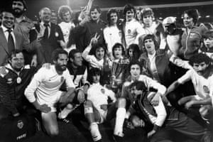 The jubilant Valencia players celebrate with the trophy.