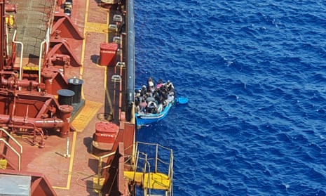 A group of migrants in a boat alongside the Maersk Etienne tanker, off the coast of Malta.