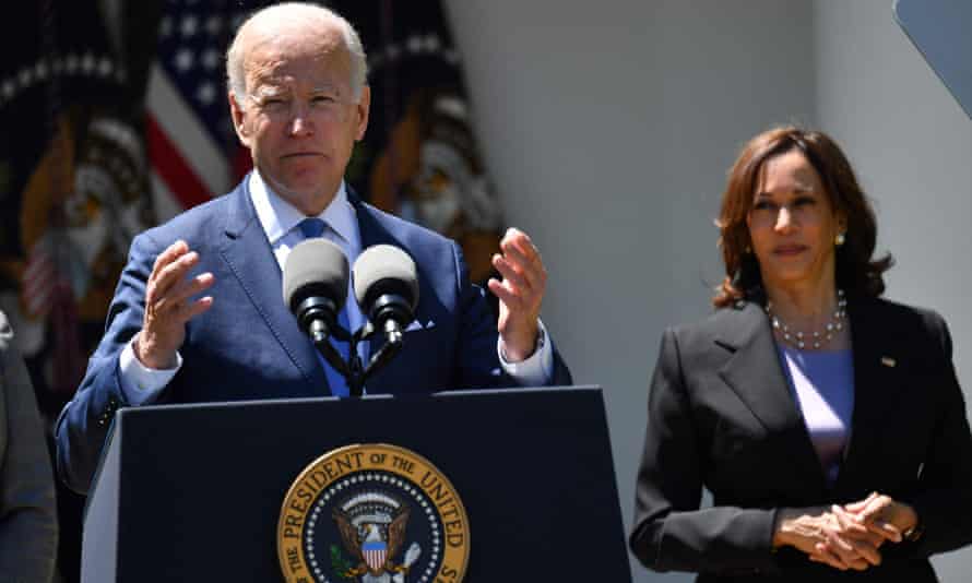 Joe Biden speaks at the White House, watched by vice-president Kamala Harris.