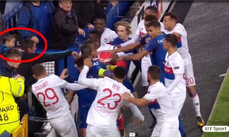 An Everton fan aims a punch at a Lyon player during a Europa League match.