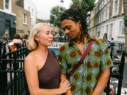 A woman holding on to a man’s arm and smiling at him as he smiles back