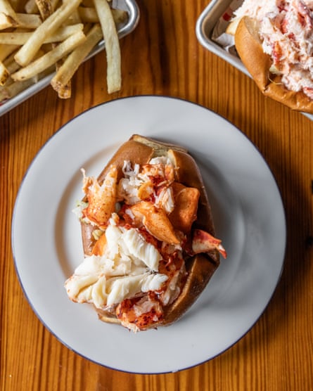 Lobster meat in rolls alongside fries