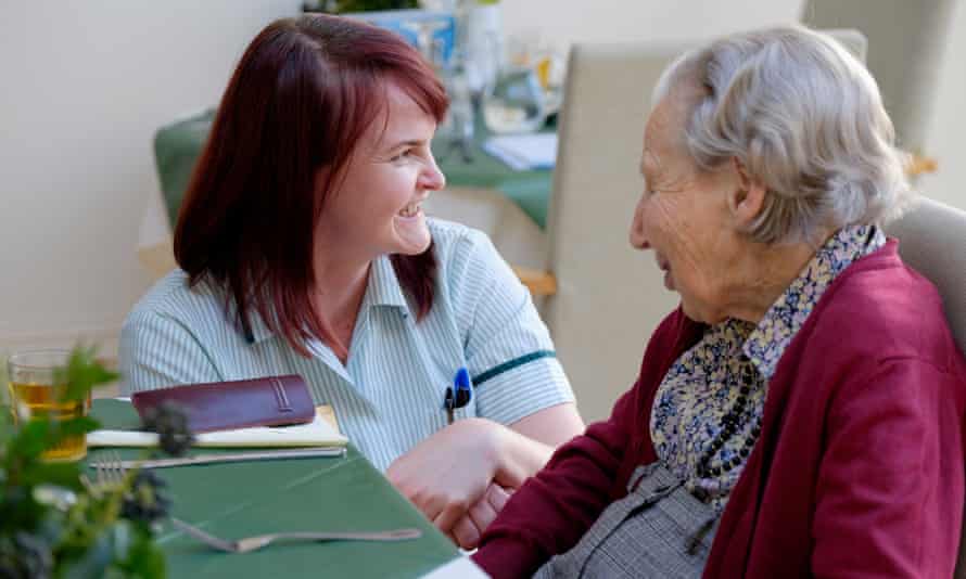 Olla Szychulska (left), lead carer at Birtley House in Surrey, speaks to resident Alison Robertson
