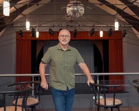 Mark Hammond stands in a small concert venue