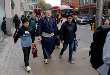 Aonishiki, who fled from war-torn Ukraine to be a sumo wrestler in Japan, walks down Kensington high street with fans as he goes for lunch near his hotel