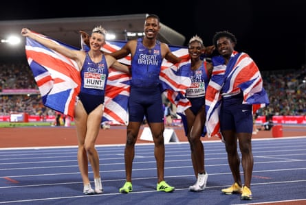 Dina Asher-Smith poses with Union Jack flags with teammates Amy Hunt, Zharnel Hughes and Jeremiah Azu