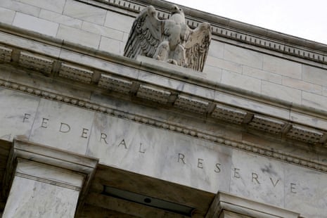 A stone eagle sits atop the US Federal Reserve building.