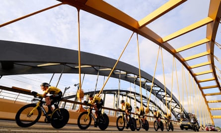 The Jumbo-Visma team cross a bridge during the opening time trail in Utrecht.