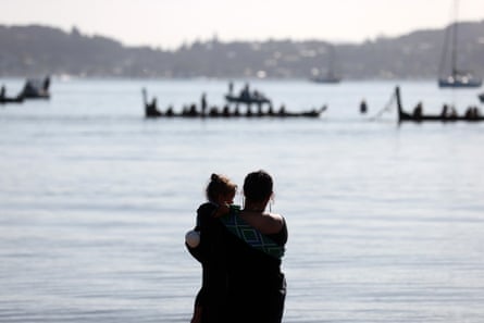 people look at boats on the water