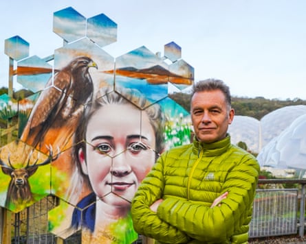 Chris Packham standing in front of a mural.