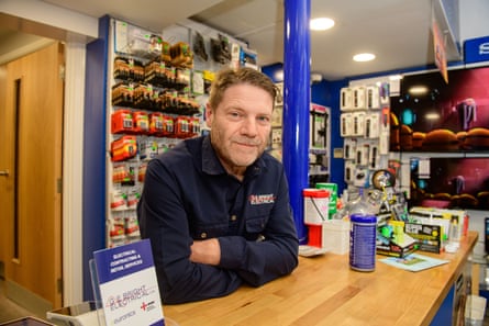 Bright leans on a counter in his shop.