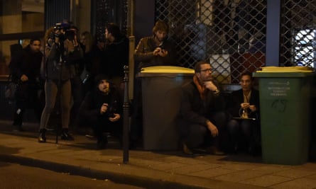 Journalists take cover near the Bataclan concert hall.