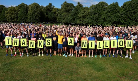 A large group of runners holding a sign saying Thanks a Million