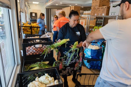 People packing food into a bag