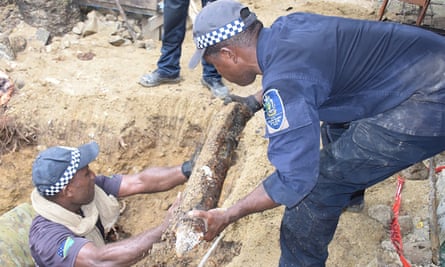 Police remove an unexploded ordnance near a school in Solomon Islands.