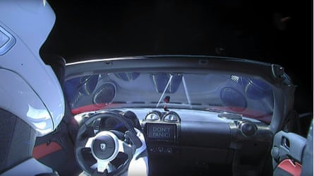 This still image taken from a SpaceX livestream video shows “Starman” sitting in SpaceX CEO Elon Musk’s cherry red Tesla roadster after the Falcon Heavy rocket delivered it into orbit around the Earth on February 2, 2018. Screams and cheers erupted at Cape Canaveral, Florida as the massive rocket fired its 27 engines and rumbled into the blue sky over the same NASA launchpad that served as a base for the US missions to Moon four decades ago.