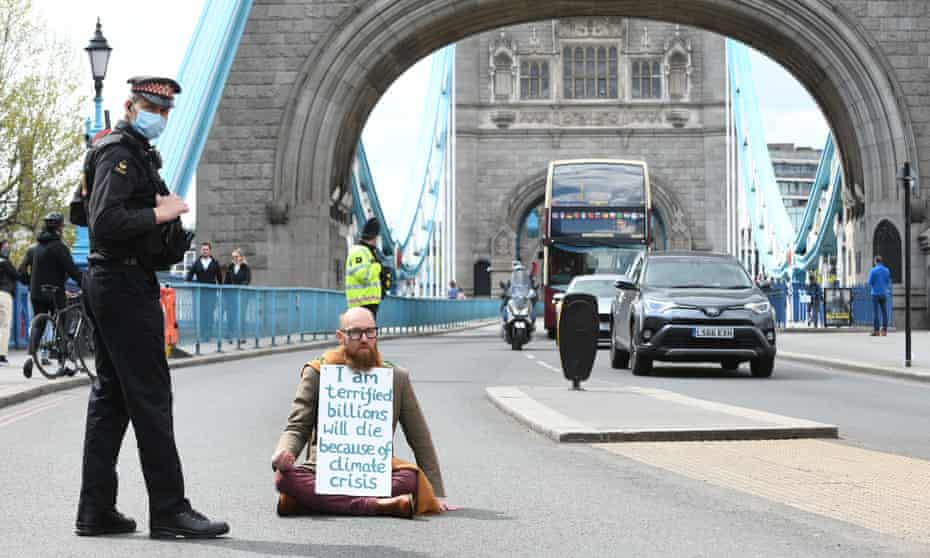 Morgan Trowland, 38, pictured blocking traffic on Tower Bridge in London.