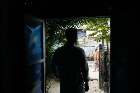 Silhouette of a man standing in a doorway