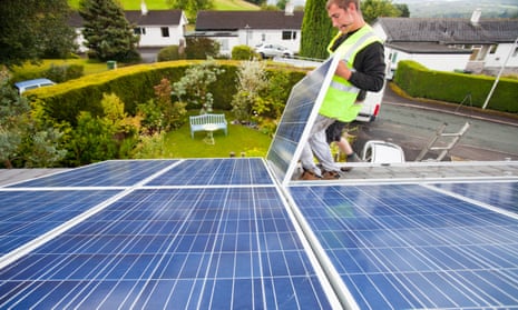 Photovoltaic panels are fitted to the roof of a house in Ambleside, UK.
