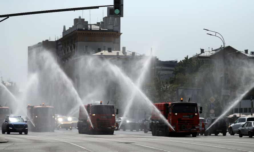 Trucks spray water in Sadovoye Koltso Street in Moscow to protect the road surface from overheating.