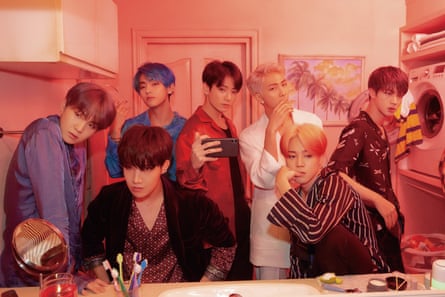 BTS looking in a mirror, with toothbrushes etc visible