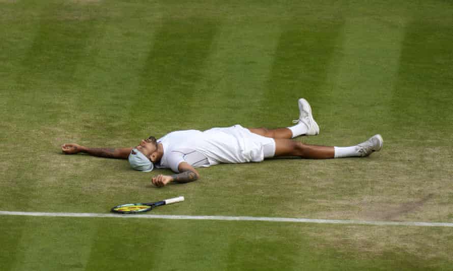 Australia’s Nick Kyrgios lies on the ground after defeating Chile’s Cristian Garin during a men’s singles quarter-final match on day 10 of the Wimbledon tennis championships in London