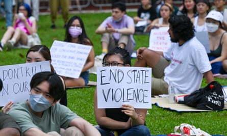 Protester holds sign saying end state violence