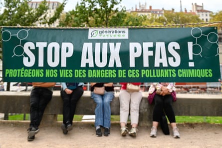 A large banner with the words ‘Stop Pfas, protect our lives from the hazards of these chemical pollutants’, is hung between two trees during a protest in Lyon, France.