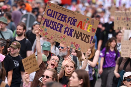 Protesters hold a sign that reads: "Glitter for everyone, except for Nazis"
