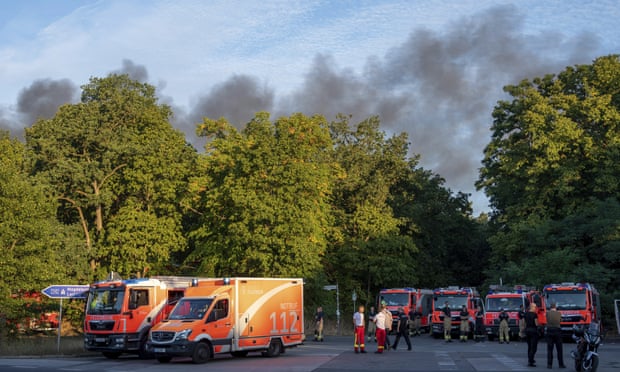 Fire trucks and ambulances on standby at the Grunewald forest in Berlin.