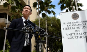 Hawaii’s attorney general, Douglas Chin, answers questions from the media outside the US district court in Honolulu.