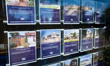 Signs in the window of a real estate agency in the Gourmet Ghetto neighborhood of Berkeley, California