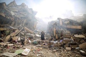A resident of al-Zahra walks through the rubble of homes destroyed in Israeli airstrikes, Gaza City, 19 October 2023