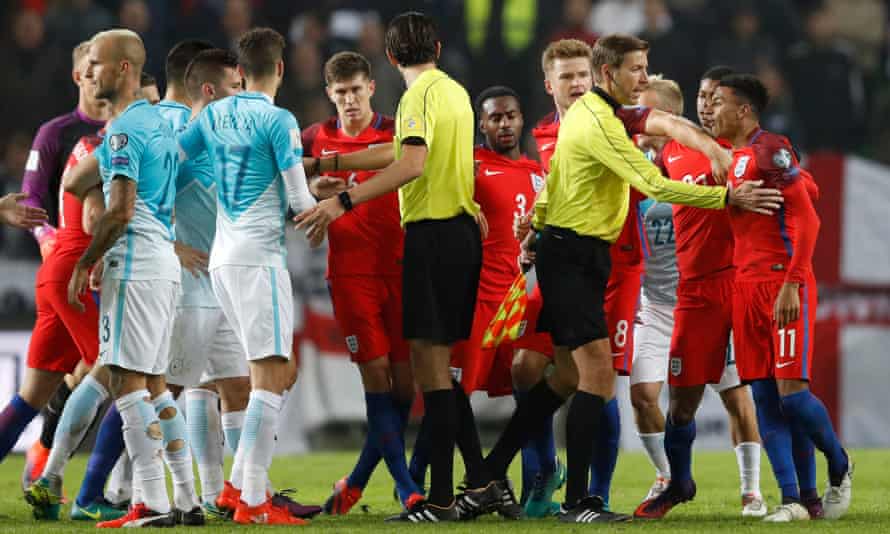 Jesse Lingard, right, looks agrieved as players from both sides clash as referee Deniz Aytekin intervenes.