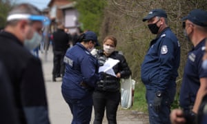 Police check a woman’s papers in the largest Roma neighbourhood of Sofia, Bulgaria