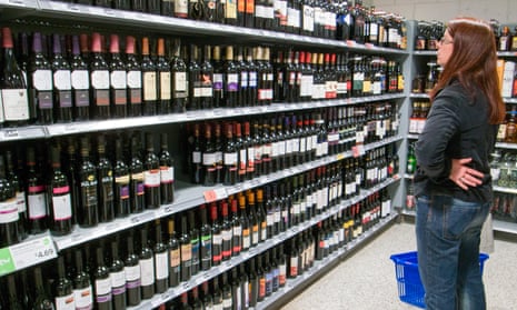 Customer choosing wine in supermarket