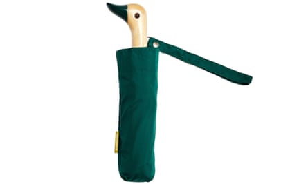 A folded down green umbrella with a wooden duck head as the handle