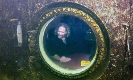 In this photo provided by the Florida Keys News Bureau, Dituri peers out of a large porthole.