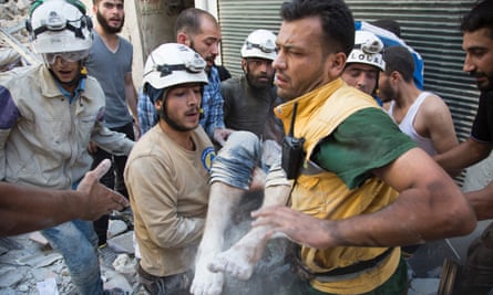 Under siege: Syrian Civil Defence volunteers, known as White Helmets, dig a body out of the rubble after an airstrike in Aleppo.