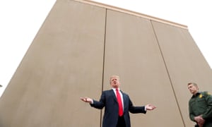 Donald Trump stands by US-Mexico border wall prototypes near San Diego, California. Congress approved no funds for these designs to be built in its latest budget.