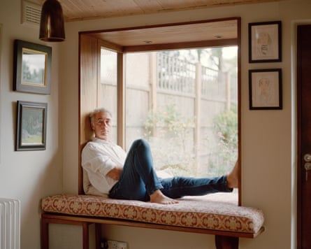Greg Wise photographed sitting in a garden window