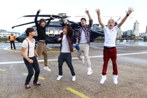 One Direction band members in front of a helicopter in September 2011