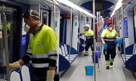 Workers clean a train to help prevent the spread of coronavirus in Madrid, Spain.