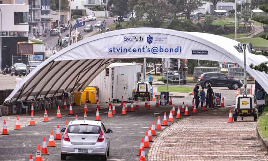 People arrive for a Covid-19 PCR test at the St Vincent’s drive-through clinic at Bondi Beach, Sydney