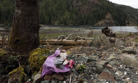 Flowers for a pregnant orca mother who died after being caught when the tide went out are left next to the lagoon off Vancouver Island