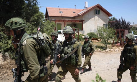 Israeli soldiers outside the house where the girl was killed